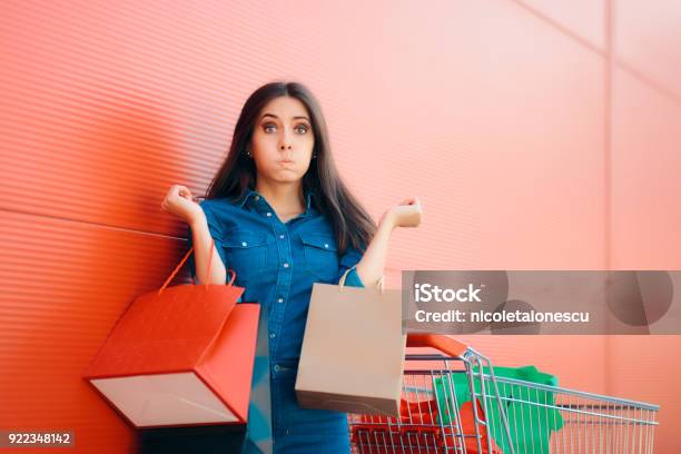 Unhappy Shopper Woman With Shopping Cart In Front Of Store Stock Photo - Download Image Now
