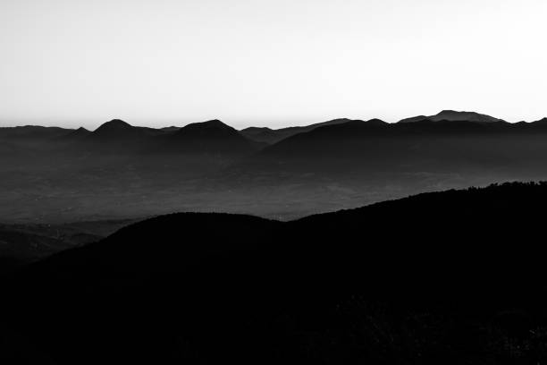 istock Silhouette of mountain peaks at sunset, under a big , almost empty sky 922348284