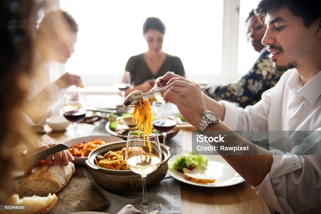 Friends gathering having Italian food together Eating Stock Photo