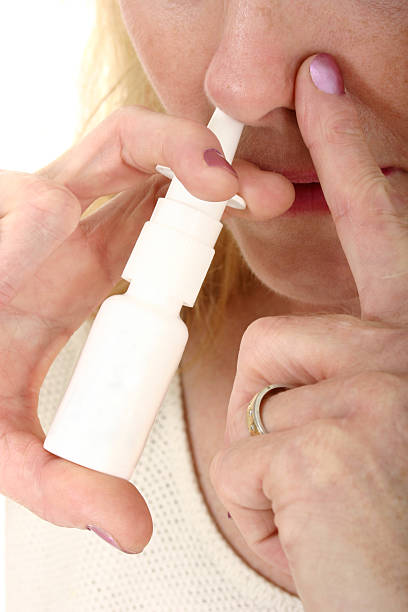 istock Woman Spraying Nasal Spray 1 92234928