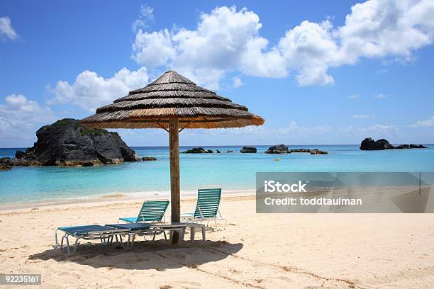 A Sunny Caribbean Beach With A Parasol Stock Photo - Download Image Now - Bermuda, Beach, Blue