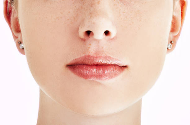 Cropped close-up of natural beauty's closed mouth The closed mouth and full lips of a beautiful young woman closed mouth stock pictures, royalty-free photos & images