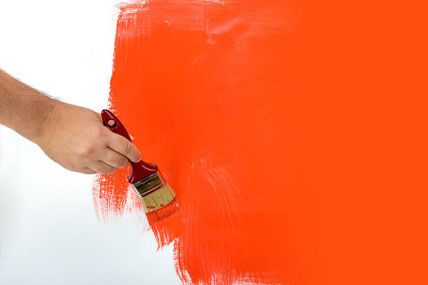 istock Painting the wall red with a paint brush 92236070