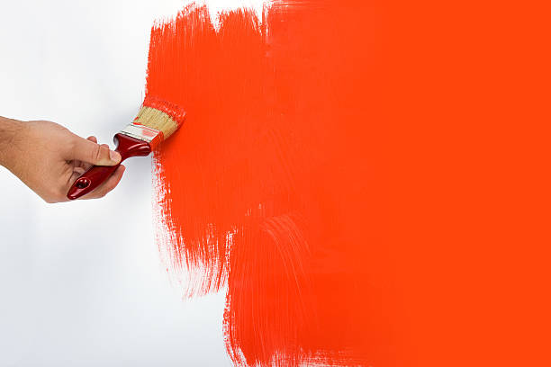 istock Man painting a wall bright red  92236074