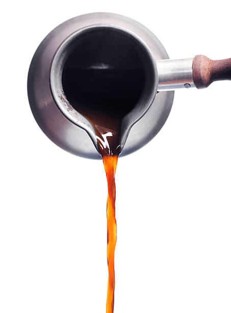 Hot coffee being pouring into a cup stock photo