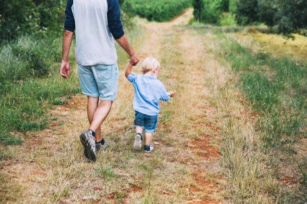 istock Father and son walking on nature, outdoors. 922362750