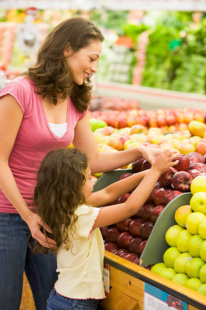 istock Mother and daughter in produce section 92237194