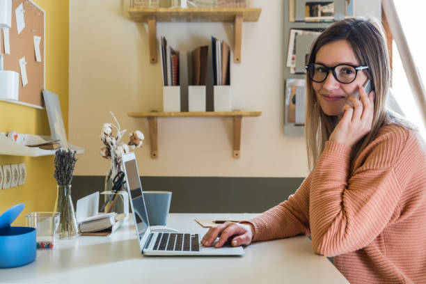 istock Young woman talking on the phone at work 922372600