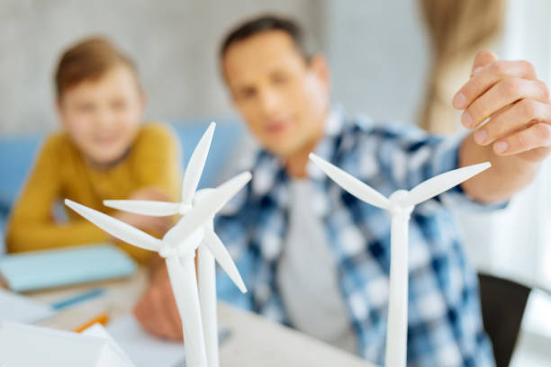 istock Young father pointing at wind turbines 922373228