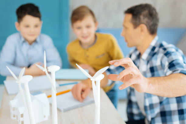 istock Young father telling his sons about wind turbines 922373330