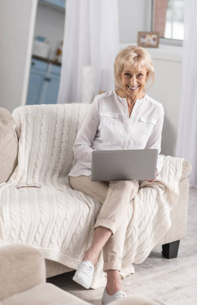 istock Pleasant mature woman using laptop 922376026