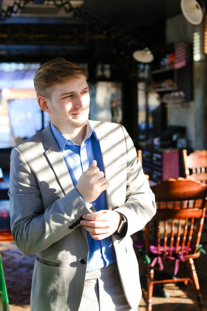 istock Young blonde man preparing for job interview and adjusting suit 922376424