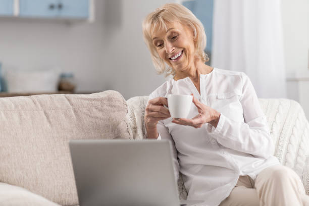 istock Happy mature woman watching comedy 922376618