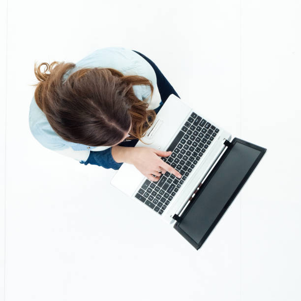 istock High angle view of young woman using a laptop 922379438