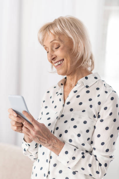 istock Joyful mature woman answering message 922379740