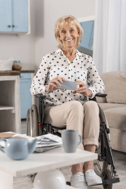 istock Mature disabled woman holding phone 922379934
