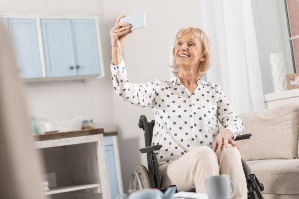 istock Handicapped mature woman taking selfie 922380006