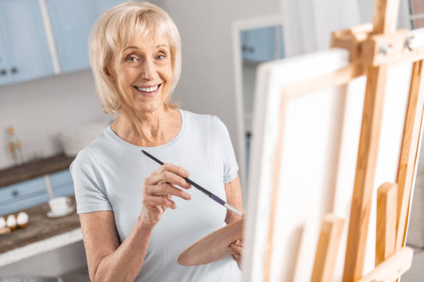 istock Joyful mature woman enjoying hobby 922380264