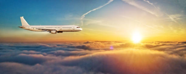 istock Airplane jetliner flying above clouds in beautiful sunset light. 922383152