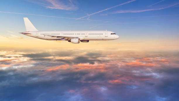 istock Airplane jetliner flying above clouds in beautiful sunset light. 922383198