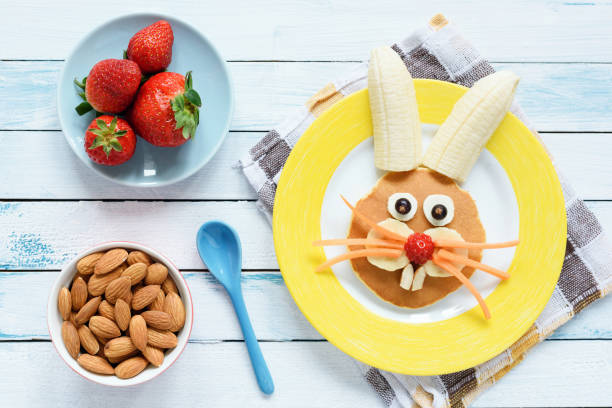 Healthy Easter Breakfast For Kids. Easter Bunny Shaped Pancake With Fruits Healthy Easter Breakfast For Kids. Easter Bunny Shaped Pancake With Fruits. Top View bunny pancake stock pictures, royalty-free photos & images