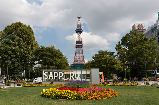 Sapporo, Japan - September 1, 2015 : Odori Park in Sapporo, Hokkaido, Japan. Throughout the year, many events are held in the Odori Park. The Sapporo TV Tower have an observation deck, souvenir shop and restaurant. It is a famous tourist attraction in Sapporo.
