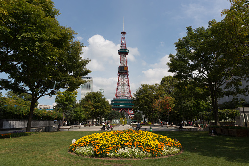 Sapporo, Japan - September 1, 2015 : Odori Park in Sapporo, Hokkaido, Japan. Throughout the year, many events are held in the Odori Park. The Sapporo TV Tower have an observation deck, souvenir shop and restaurant. It is a famous tourist attraction in Sapporo.