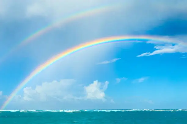 Double rainbow over the ocean. Punta Cana beach in the Dominican Republic. Nature of the Caribbean islands.