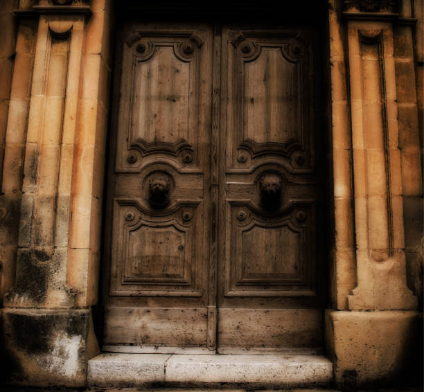 A shot of an old door of an abandoned building with scary knobs.