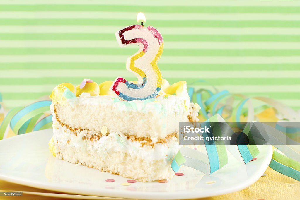 slice of third birthday cake  Cake Stock Photo