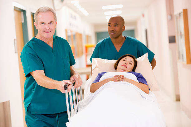 Two Orderlies Pushing patient  porter photos stock pictures, royalty-free photos & images