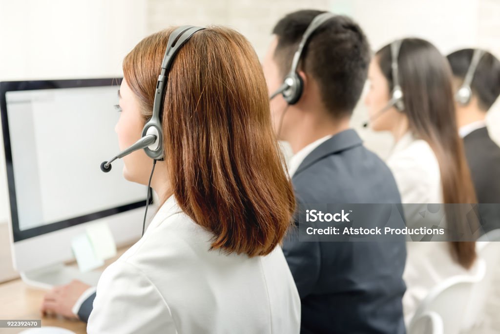 Back view of Asian telemarketing customer service agent team Back view of Asian telemarketing customer service agent team, call center job concept Cross Section Stock Photo