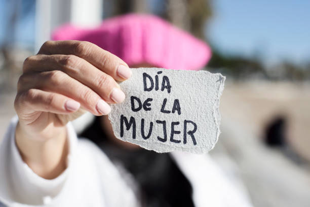 istock woman with pink hat and text womens day in spanish 922397128
