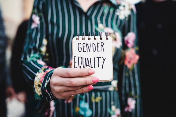 istock woman shows notepad with the text gender equality 922397278