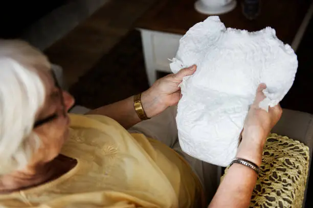 Senior woman looking at a diaper