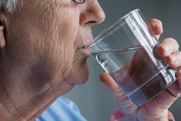 istock Side view of elderly woman drinking water 922401274
