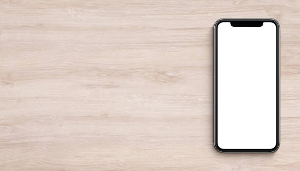 istock Smartphone mockup flat lay top view lying on wooden office desk banner with copy space 922401608