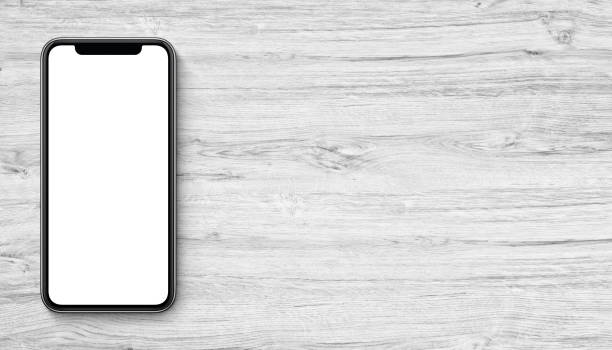 istock Smartphone mockup flat lay top view lying on wooden office desk banner with copy space 922401630