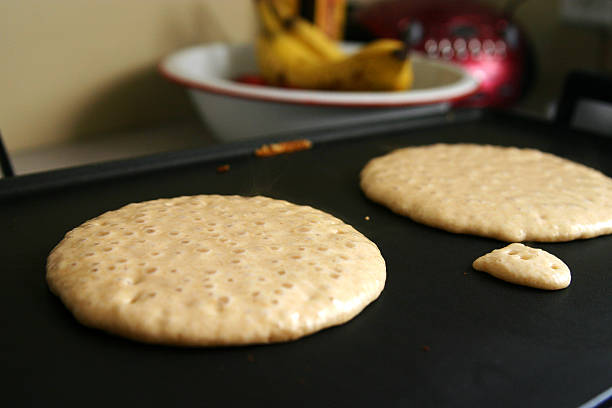 Pancakes on Griddle  pancake photos stock pictures, royalty-free photos & images
