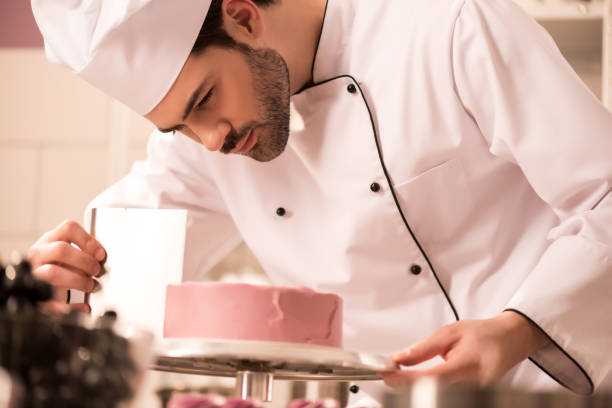 istock focused confectioner making sweet cake in restaurant kitchen 922405250