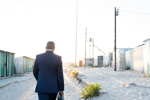 Photo of a business man in a suit walking away