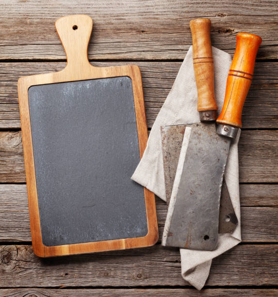 istock Butcher. Vintage meat knives and blackboard 922410086