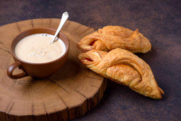 istock Closeup croissants and coffee on table 922411730