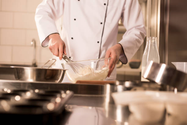 istock partial view of confectioner with whisk making dough in restaurant kitchen 922414114