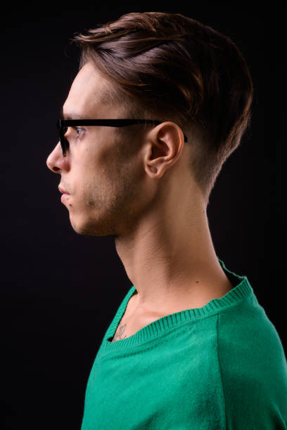 portrait of handsome man wearing eyeglasses against black background - tattoo men profile punk imagens e fotografias de stock