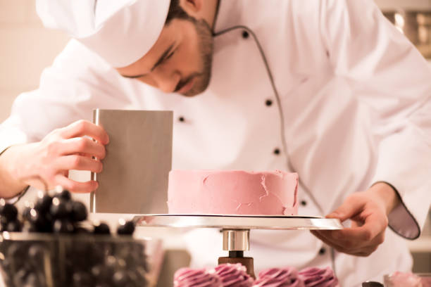 istock focused confectioner making sweet cake in restaurant kitchen 922414416