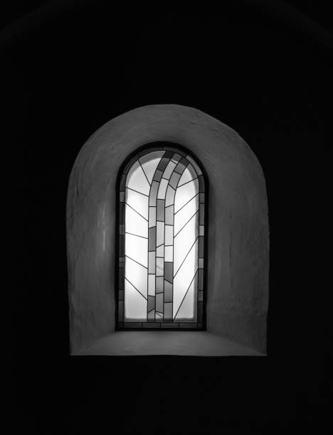 The old and ancient window in dark room .