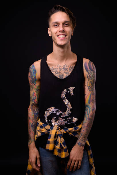 istock Happy Man With Tattoos Smiling Against Black Background 922415458