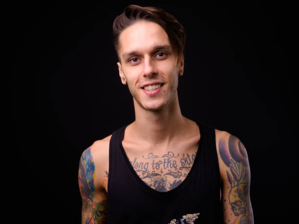 istock Happy Man With Tattoos Smiling Against Black Background 922415540