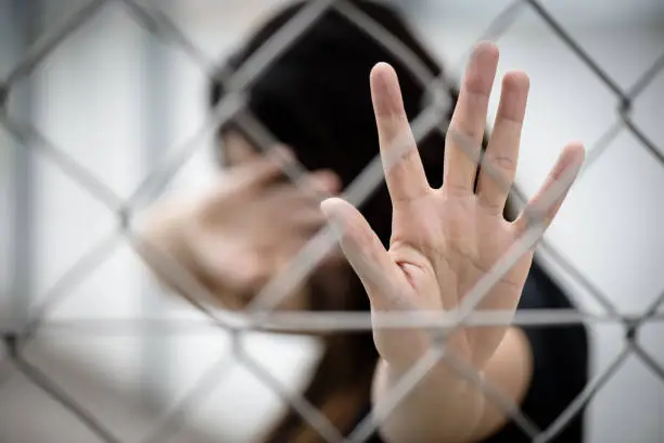 Woman hand close her face and another hand sign for stop abusing violence, Human Rights Day concept.